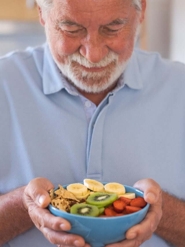 smiling-senior-man-ready-eat-salad-fresh-dried-fruits-breakfast-lunch-time-healthy-eating