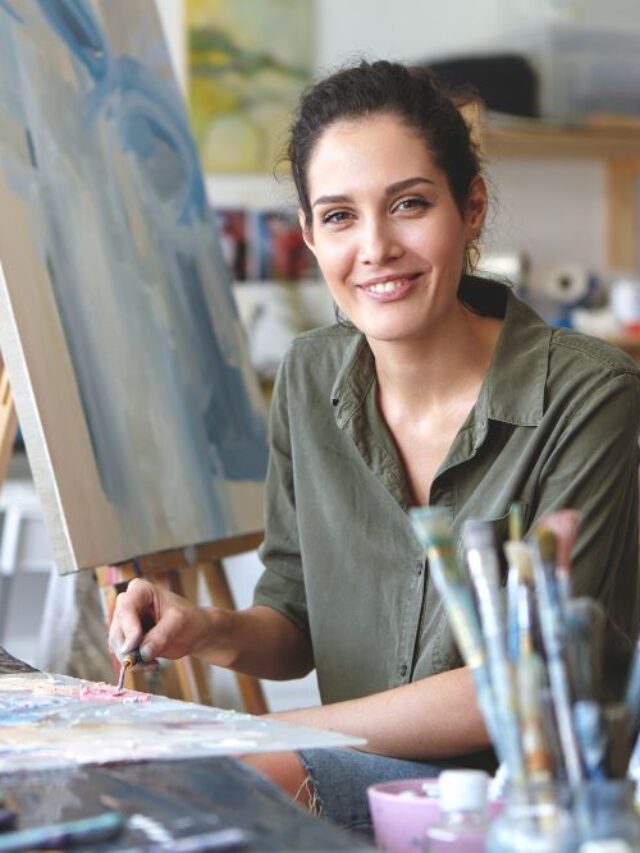 portrait-gorgeous-excited-young-brunette-female-artist-casual-blouse-khaki-color-mixing-oil-paint-palette-using-painting-knife-passionate-about-her-occupation-process-creation