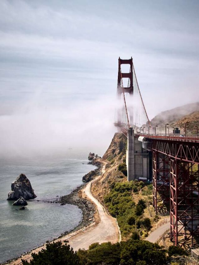 vertical-shot-golden-gate-bridge-against-misty-blue-sky-san-francisco-california-usa