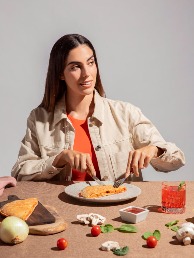 young-woman-enjoying-delicious-calzone-pizza