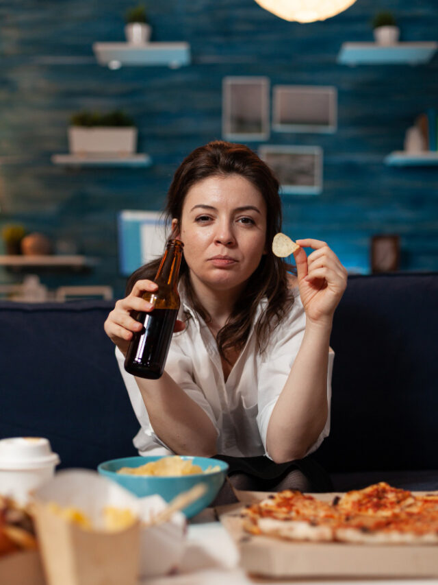 portrait-caucasian-female-looking-into-camera-holding-beer-bottle-hands